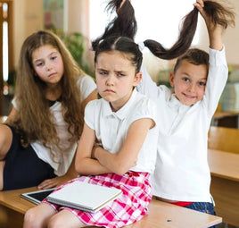 Children at a desk with boy annoying girl pulling her pigtails - Funny and motivational gifts for Kids at Giftymcgiftface.com