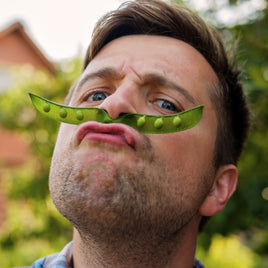 Man with a broad bean across his top lip that looks like a moustache. Funny and motivational Gifts for Men - GiftyMcGiftFace